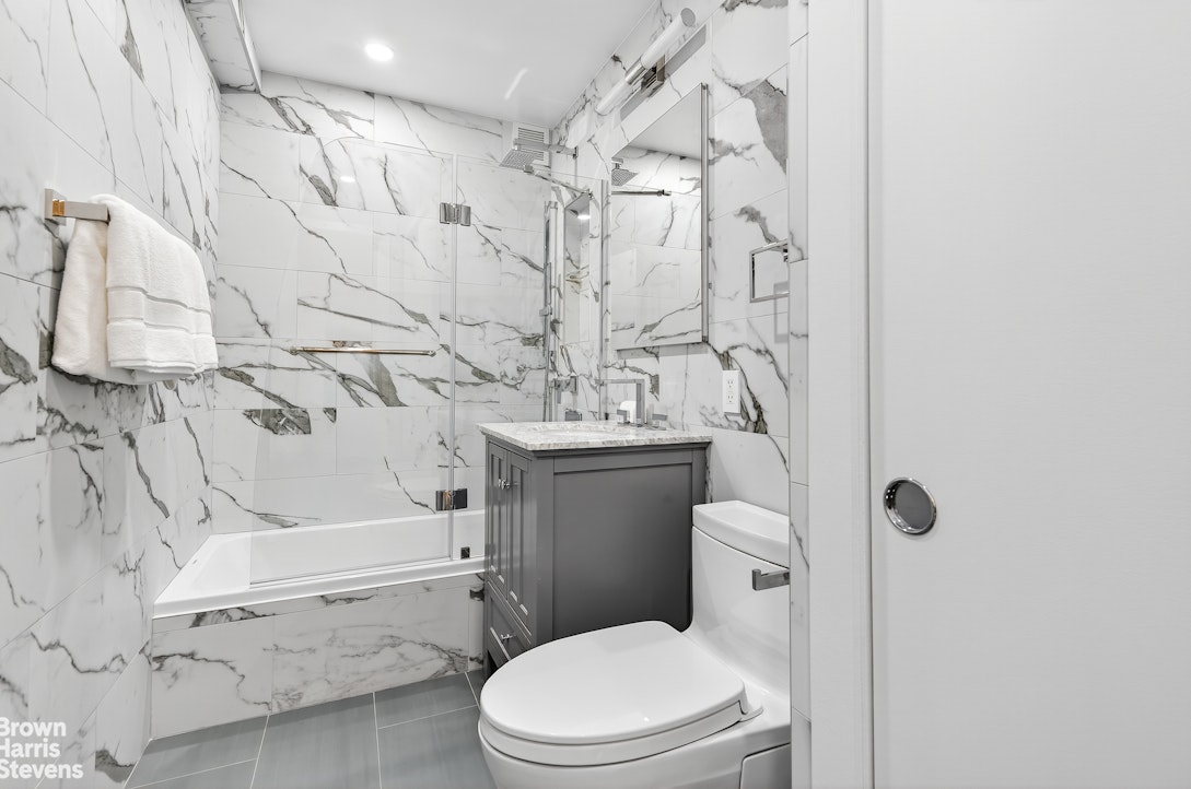 520 East 72nd Street, Unit 4J Manhattan, NY 10021 - Photo 7 of 15 a bathroom with a sink toilet and shower