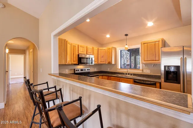 a large kitchen with a table and chairs in it