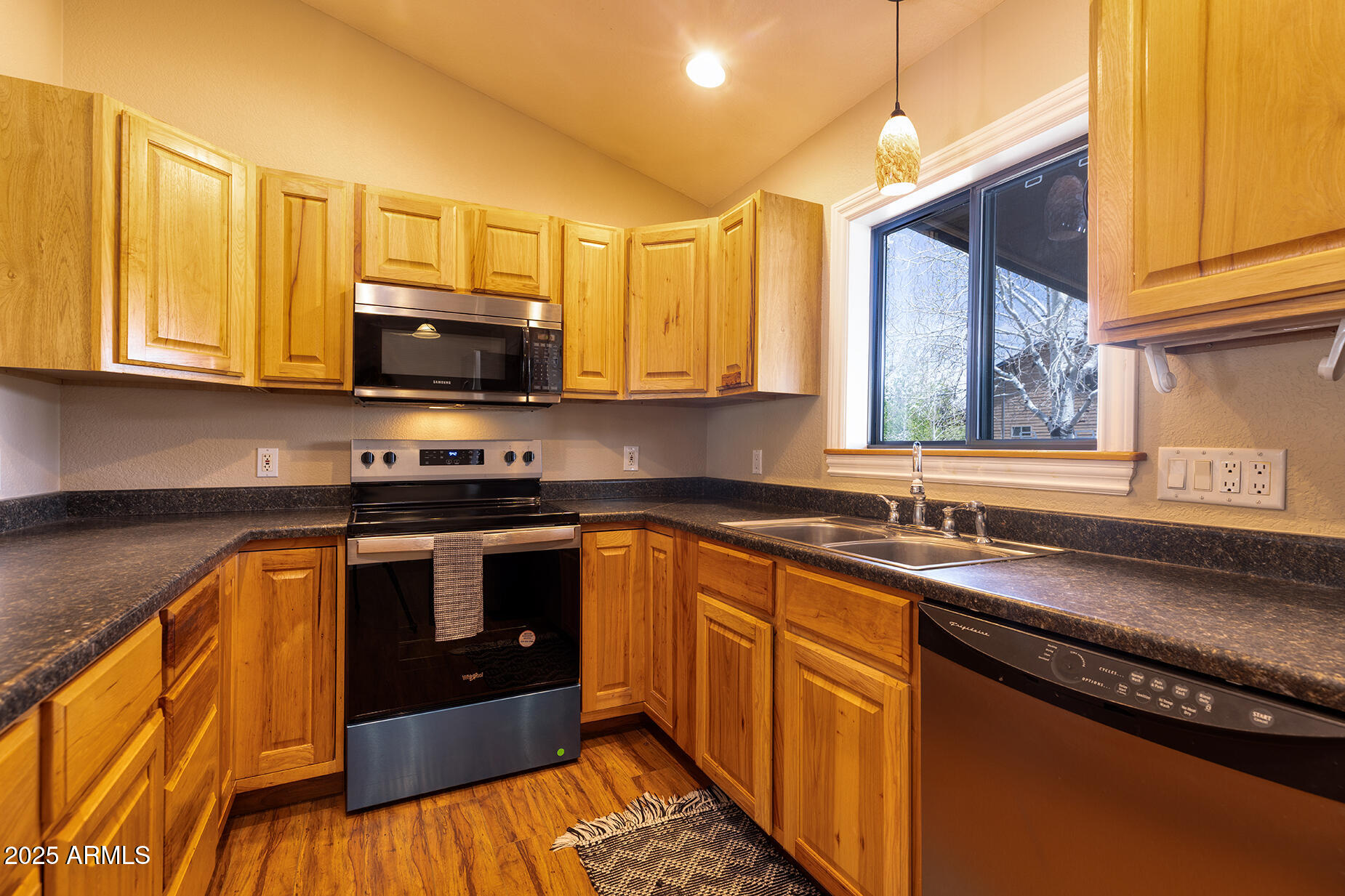 116 Skyhook Road Pinetop, AZ 85935 - Photo 15 of 32 a kitchen with stainless steel appliances granite countertop a sink a stove a microwave and wooden cabinets
