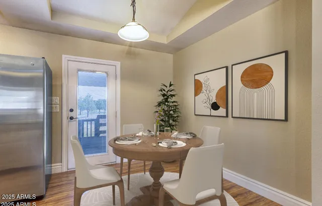 a view of a dining room with furniture and wooden floor