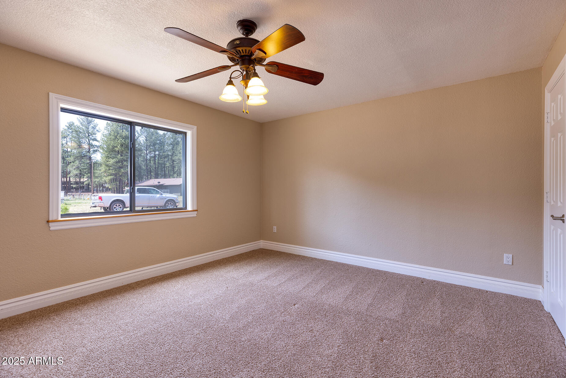 116 Skyhook Road Pinetop, AZ 85935 - Photo 20 of 32 an empty room with a window and a fan