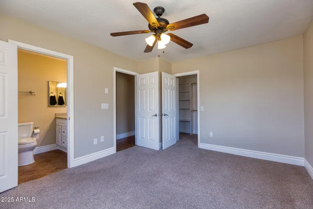 a view of an empty room and a bathroom