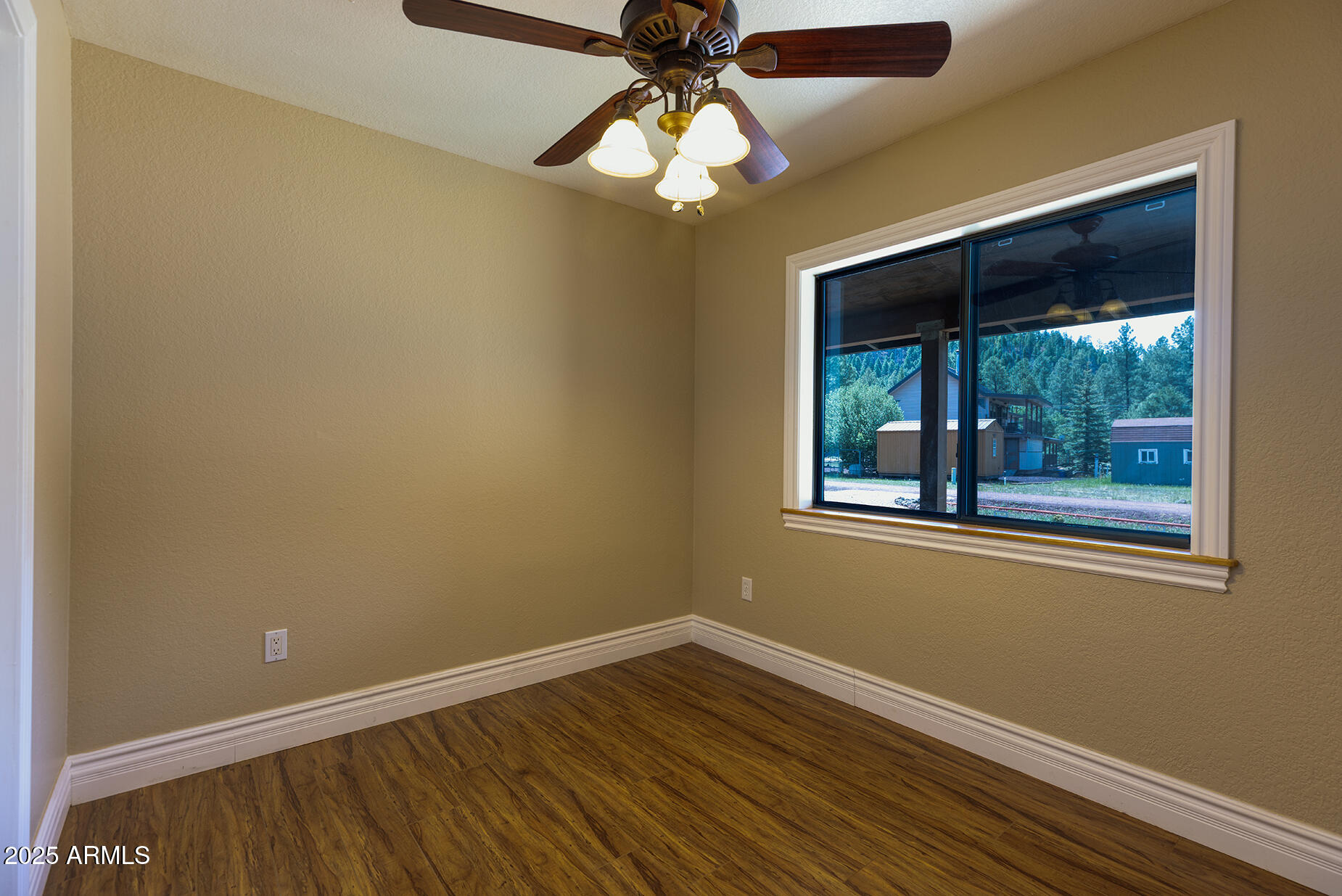 116 Skyhook Road Pinetop, AZ 85935 - Photo 27 of 32 a view of an empty room with wooden floor and a window