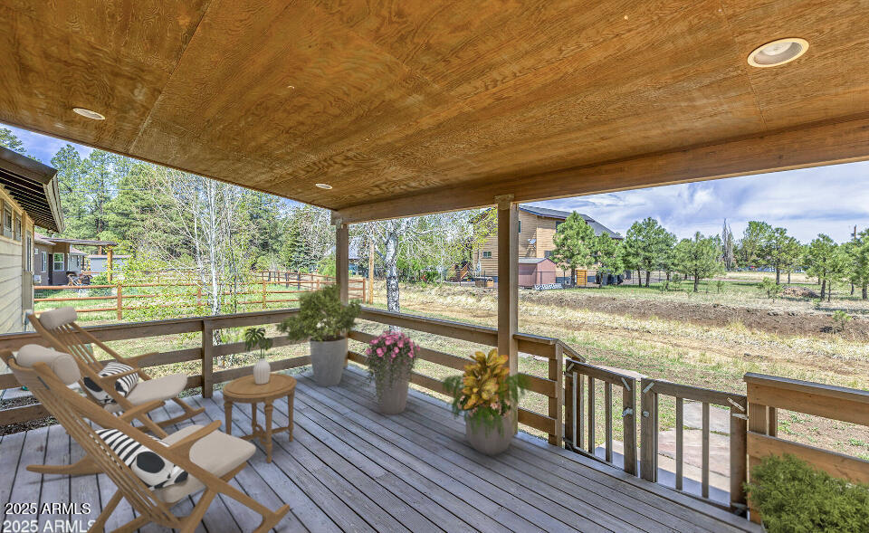 116 Skyhook Road Pinetop, AZ 85935 - Photo 3 of 32 a view of a balcony with chairs and wooden floor