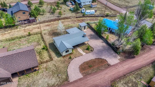 an aerial view of a house with a yard basket ball court and outdoor seating