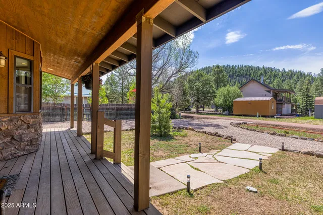 a view of a porch with wooden floor and iron stairs