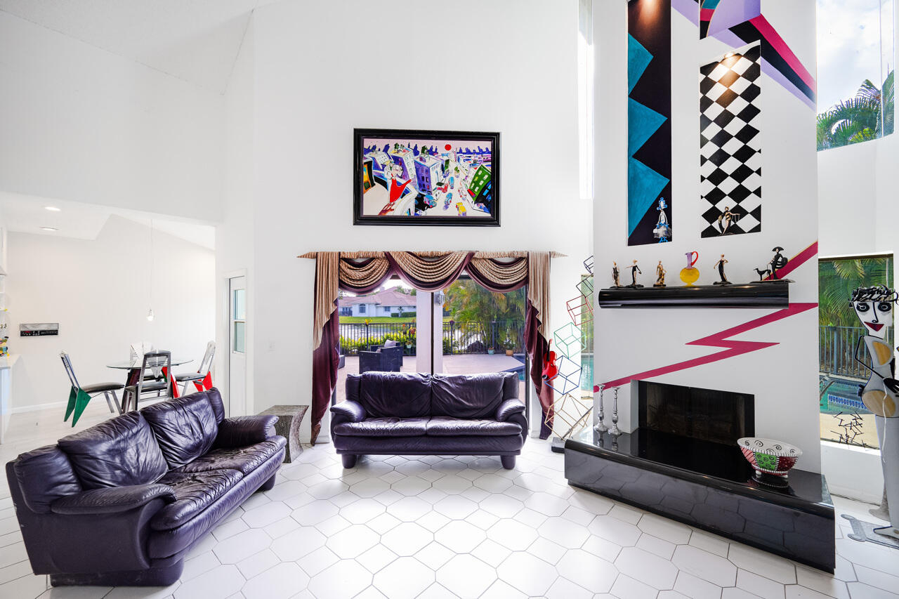 3740 Canterbury Way Boca Raton, FL 33434 - Photo 11 of 55 a living room with furniture and a fireplace