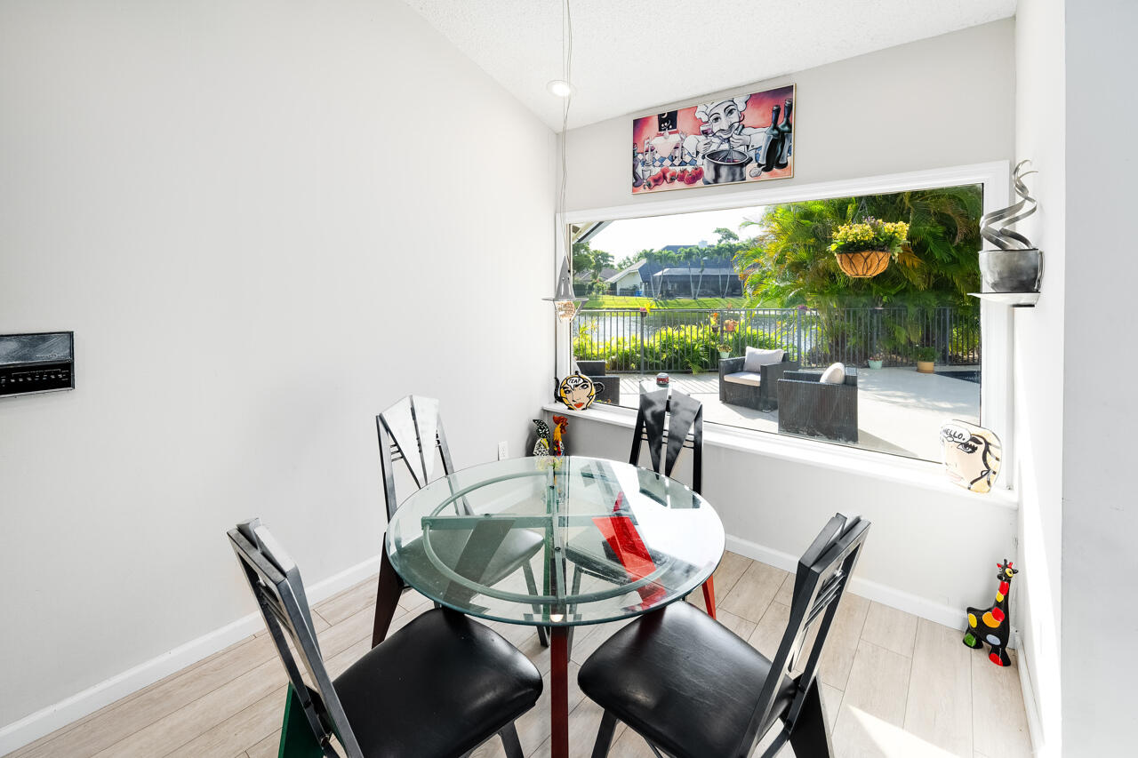 3740 Canterbury Way Boca Raton, FL 33434 - Photo 19 of 55 a view of a dining room with furniture one side kitchen view and wooden floor