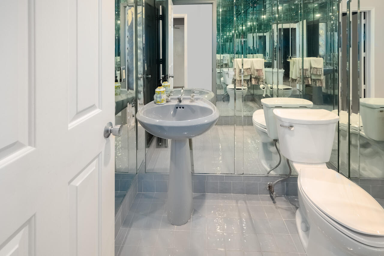 3740 Canterbury Way Boca Raton, FL 33434 - Photo 20 of 55 a bathroom with a toilet a sink and a mirror