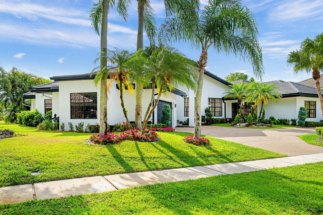3740 Canterbury Way Boca Raton, FL 33434 - Photo 2 of 55 a view of a house with swimming pool and a yard