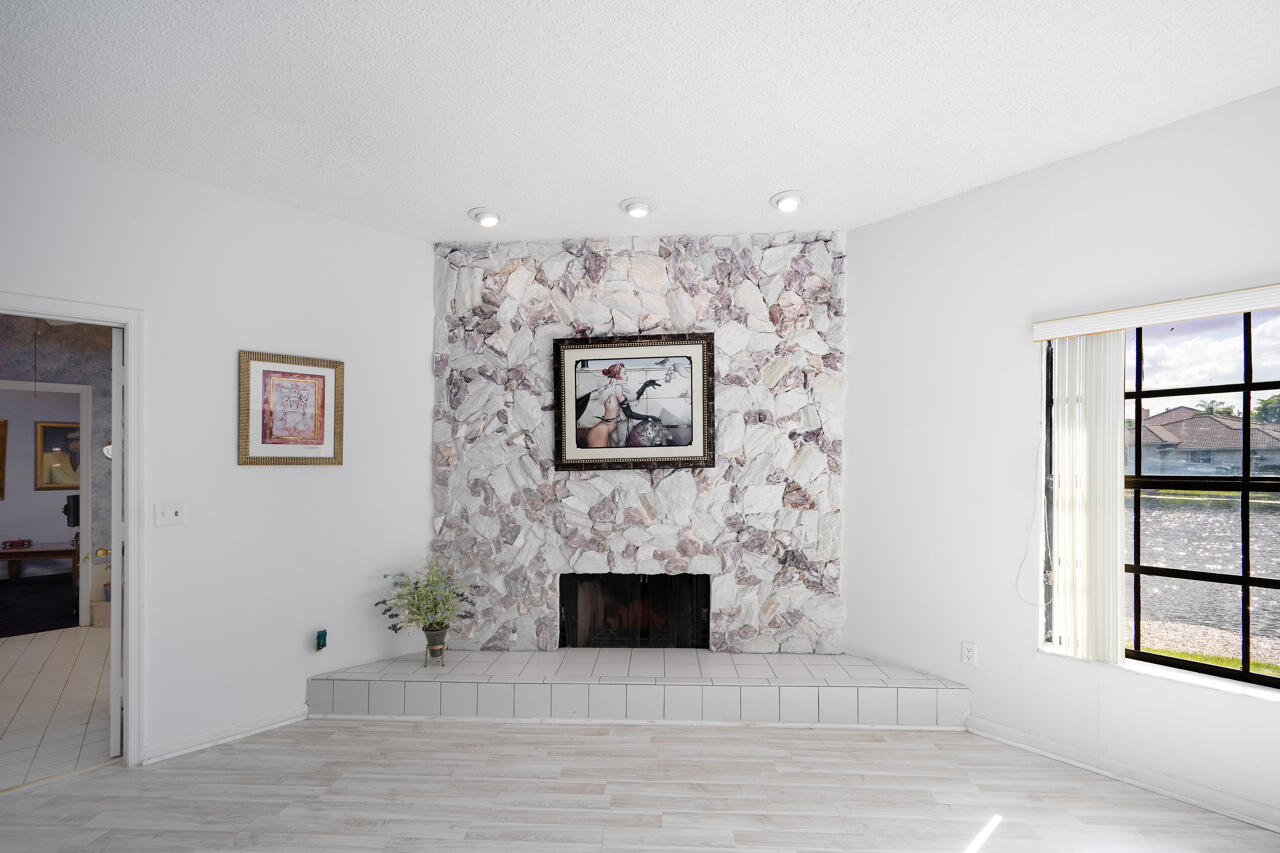 3740 Canterbury Way Boca Raton, FL 33434 - Photo 23 of 55 an empty room with windows and fireplace