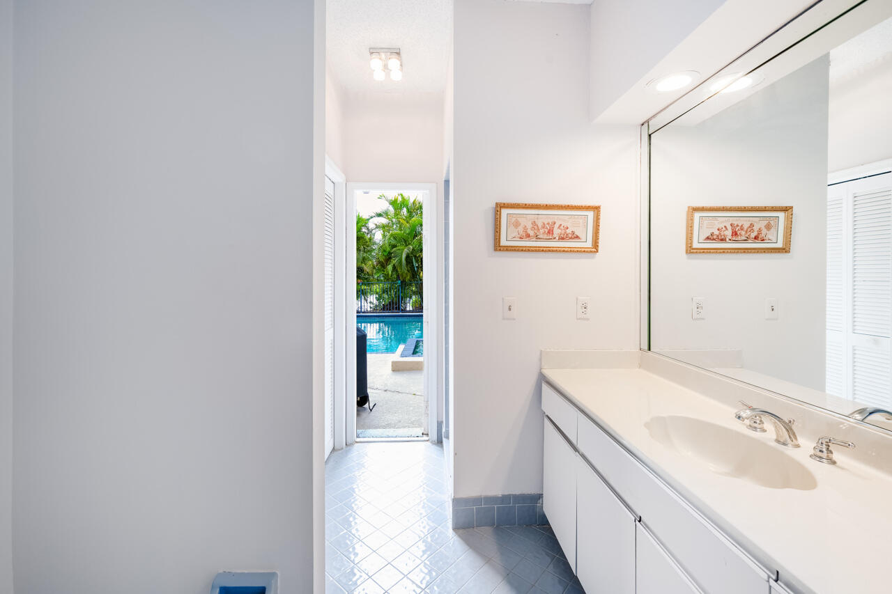3740 Canterbury Way Boca Raton, FL 33434 - Photo 40 of 55 a bathroom with a sink and a mirror