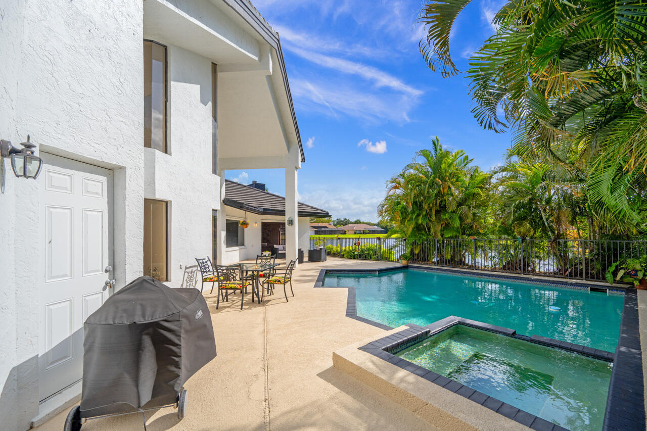 3740 Canterbury Way Boca Raton, FL 33434 - Photo 45 of 55 a view of a swimming pool with outdoor seating