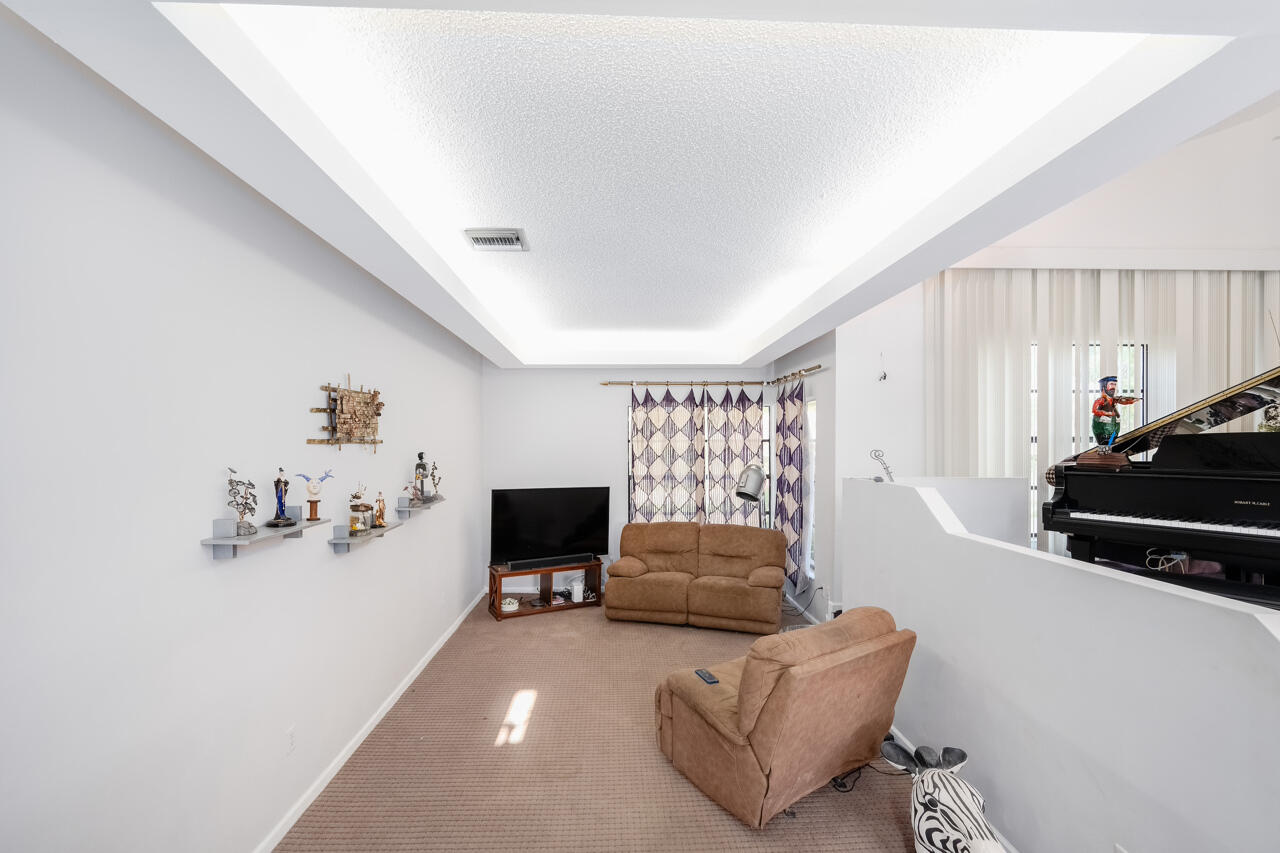 3740 Canterbury Way Boca Raton, FL 33434 - Photo 10 of 55 a living room with furniture and a flat screen tv
