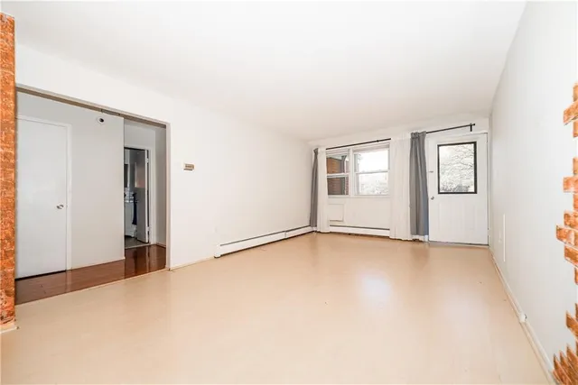 an empty room with windows and closet