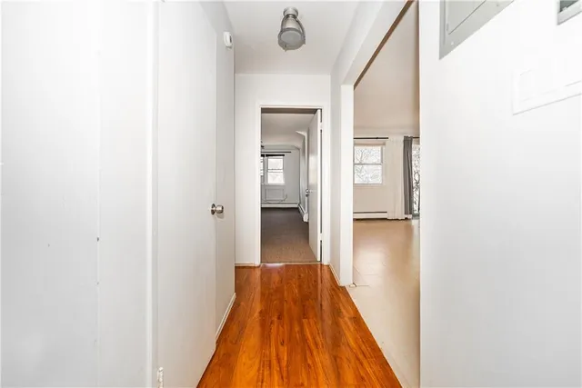 a view of a hallway with wooden floor