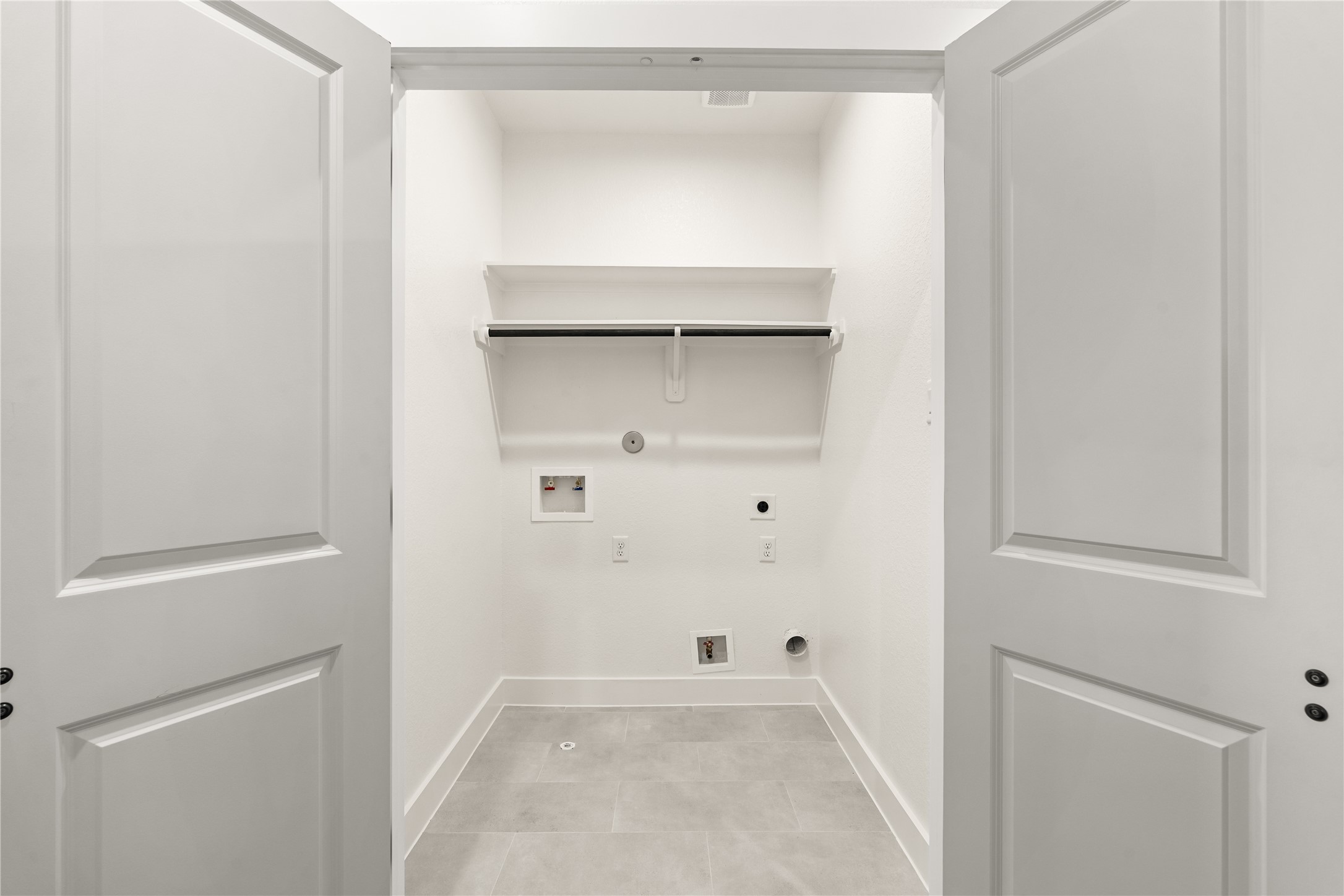 3539 Mainer Street, Unit B Houston, TX 77021 - Photo 22 of 29 Dedicated laundry room with utility connections, overhead storage, and tile floor