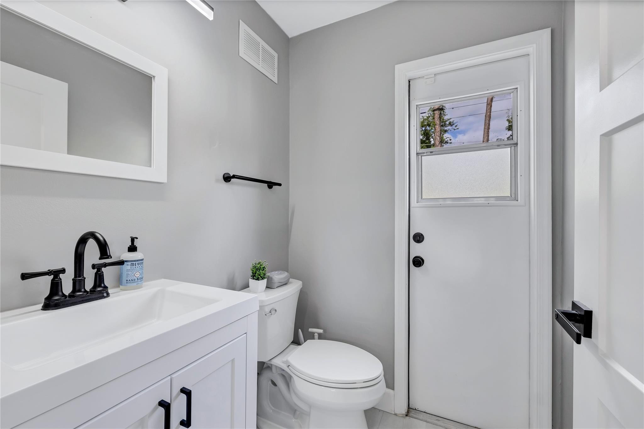8613 Windy Circle Boynton Beach, FL 33472 - Photo 12 of 51 a bathroom with a toilet sink and mirror