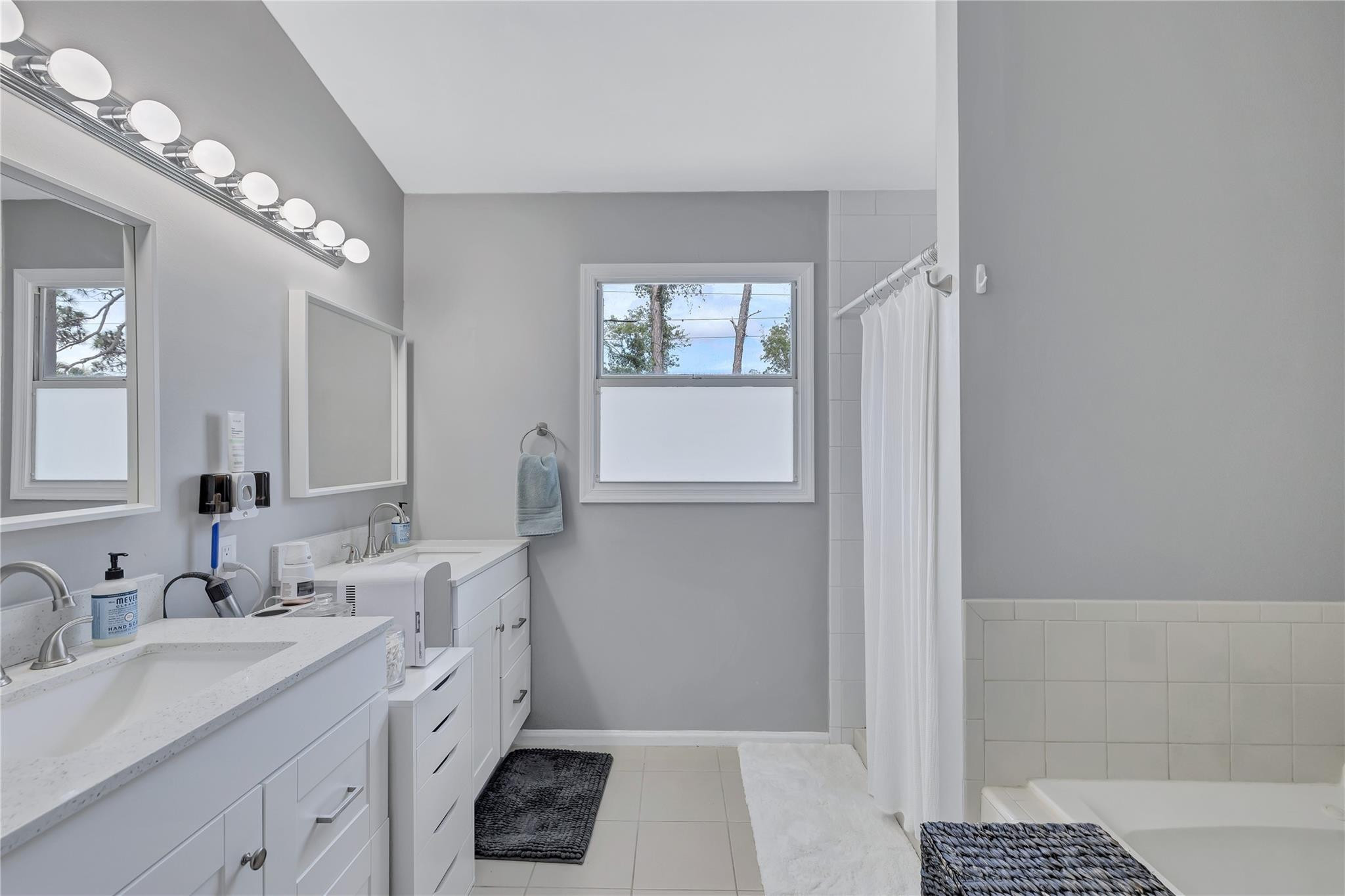 8613 Windy Circle Boynton Beach, FL 33472 - Photo 27 of 51 a spacious bathroom with a double vanity sink a mirror and a shower