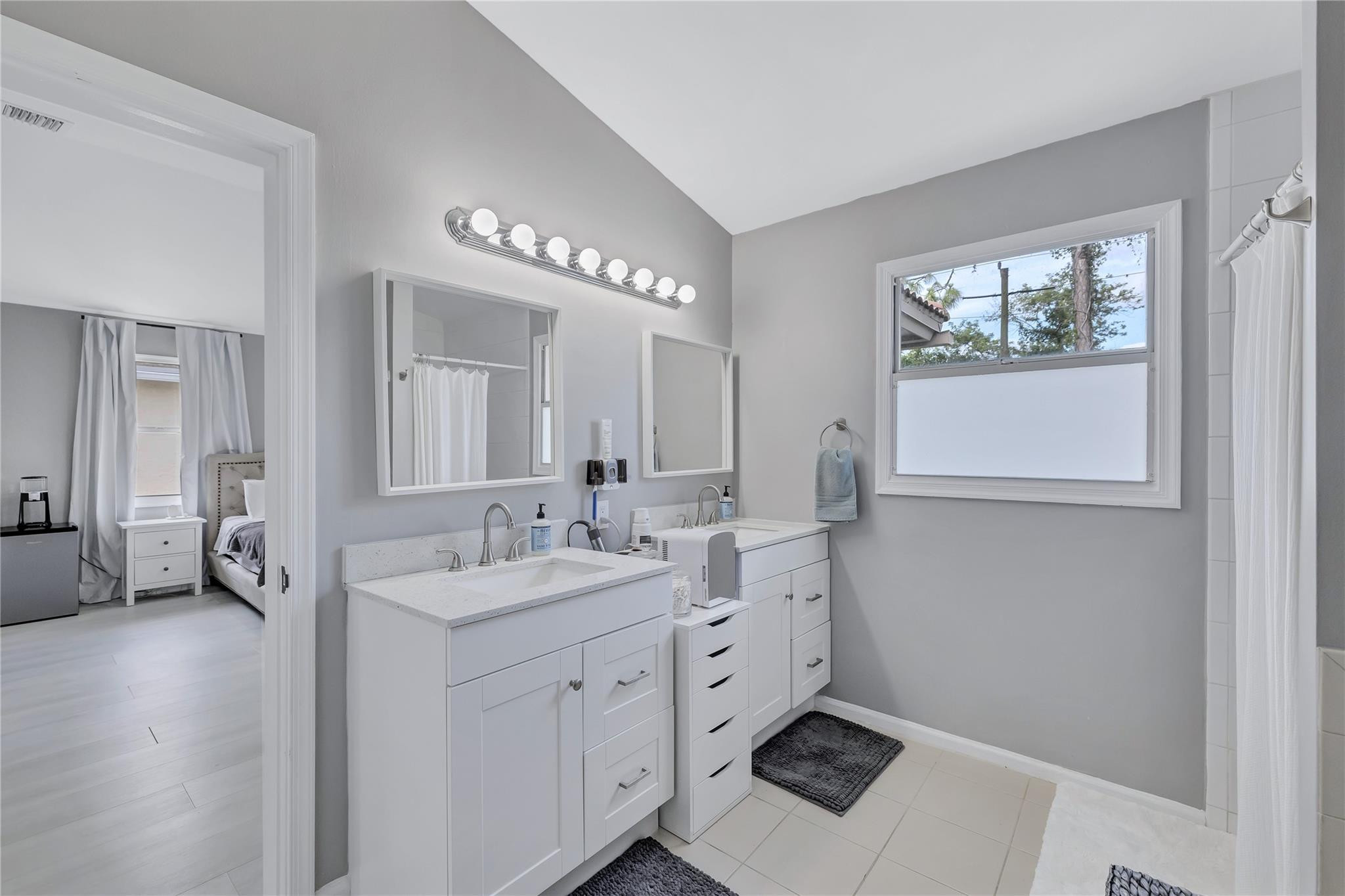 8613 Windy Circle Boynton Beach, FL 33472 - Photo 28 of 51 a spacious bathroom with a double vanity sink a mirror and a window