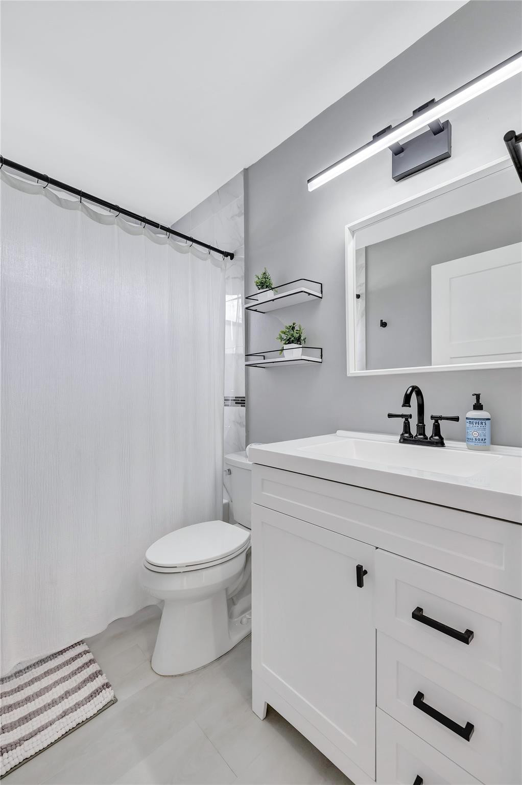 8613 Windy Circle Boynton Beach, FL 33472 - Photo 37 of 51 a bathroom with a sink a toilet and a mirror