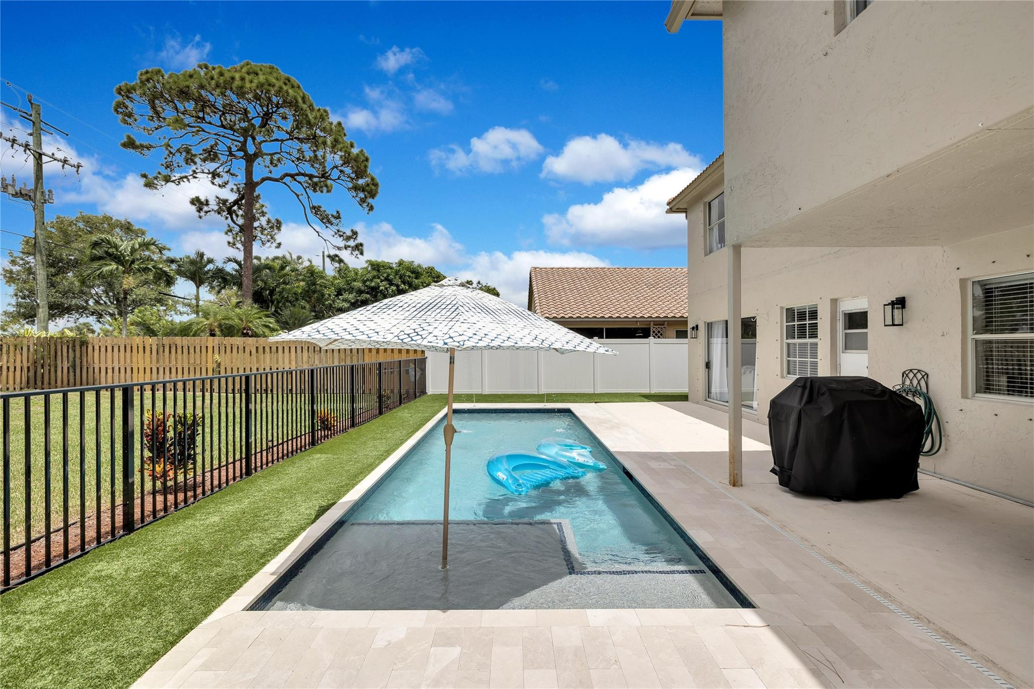 8613 Windy Circle Boynton Beach, FL 33472 - Photo 47 of 51 a view of a swimming pool with a patio