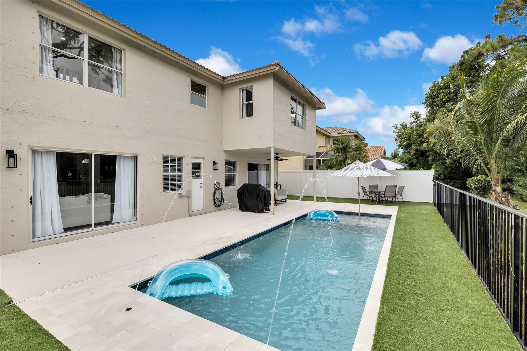 8613 Windy Circle Boynton Beach, FL 33472 - Photo 49 of 51 a view of a white house with a swimming pool
