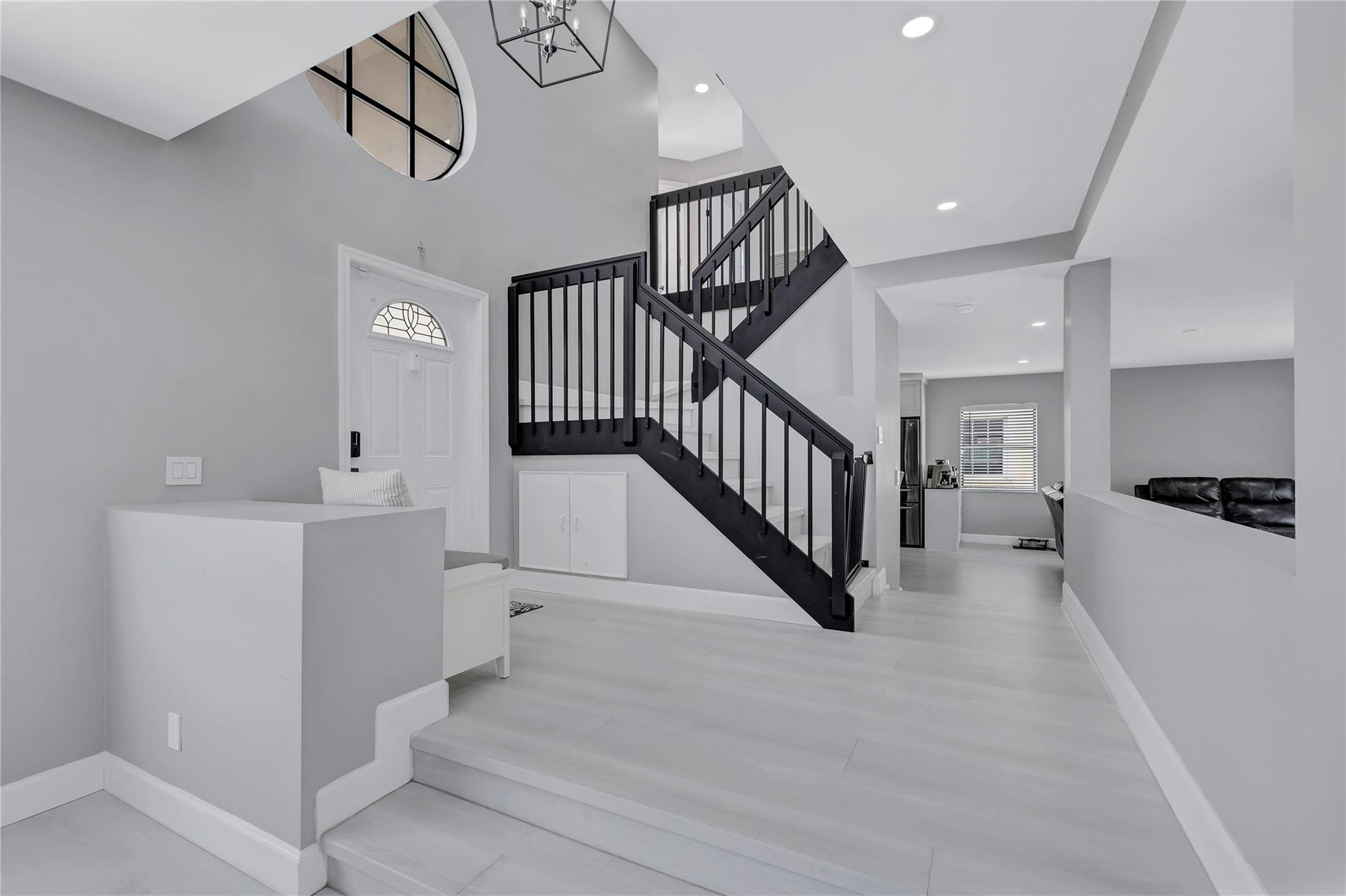 8613 Windy Circle Boynton Beach, FL 33472 - Photo 6 of 51 a view of staircase with lots of frames and a wooden floor