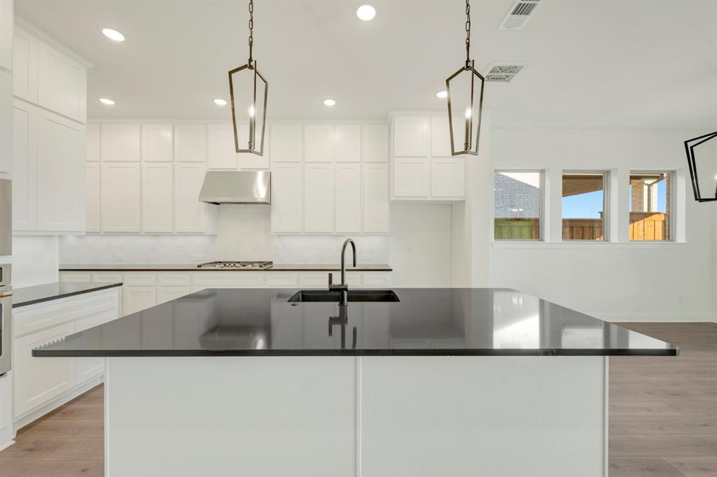 1941 Foothill Road Rockwall, TX 75087 - Photo 21 of 37 a kitchen with kitchen island a sink stainless steel appliances and cabinets