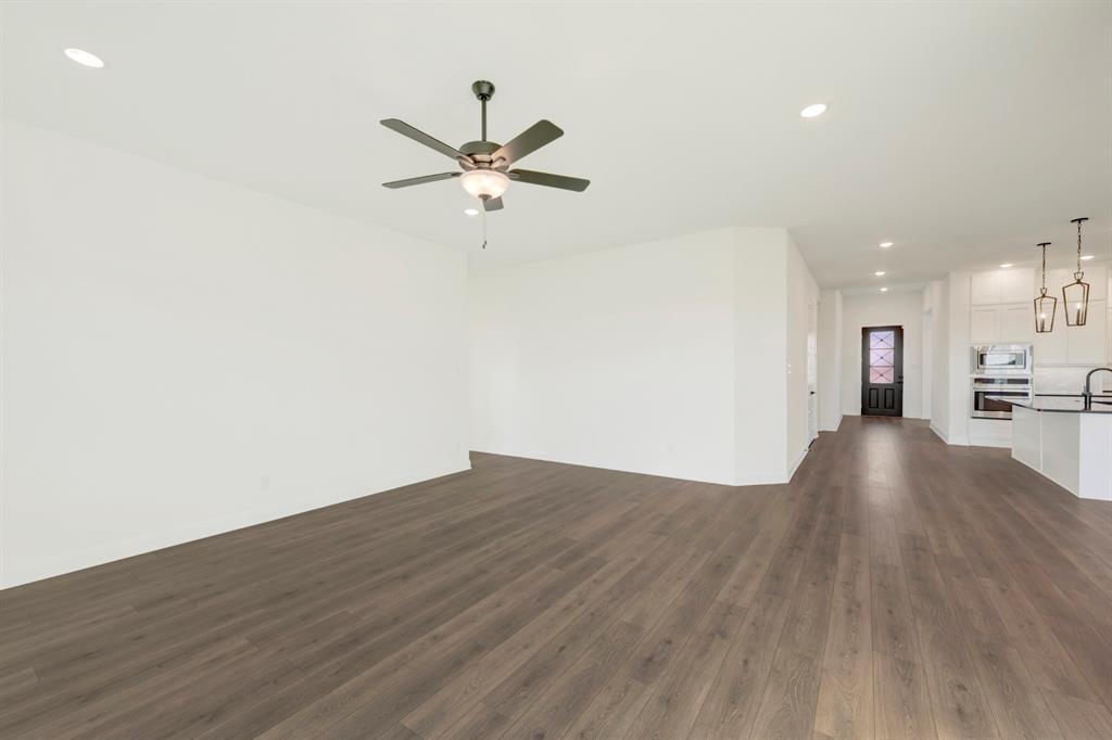 1941 Foothill Road Rockwall, TX 75087 - Photo 29 of 37 a view of a big room with wooden floor and a kitchen