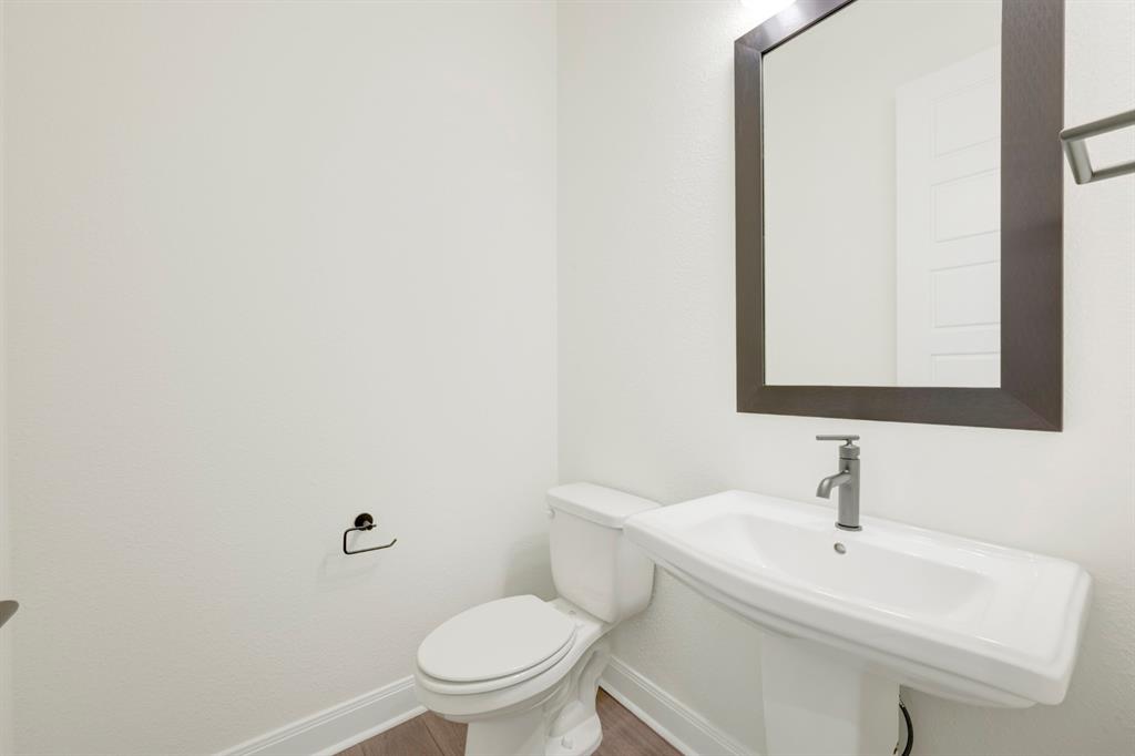 1941 Foothill Road Rockwall, TX 75087 - Photo 10 of 37 a bathroom with a sink a toilet and mirror