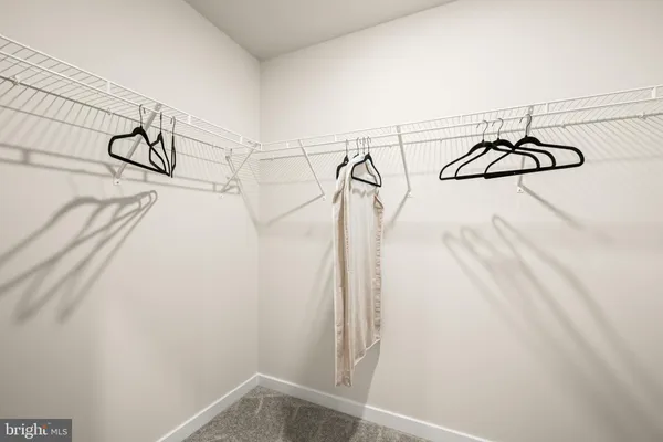 a view of a closet with white walls