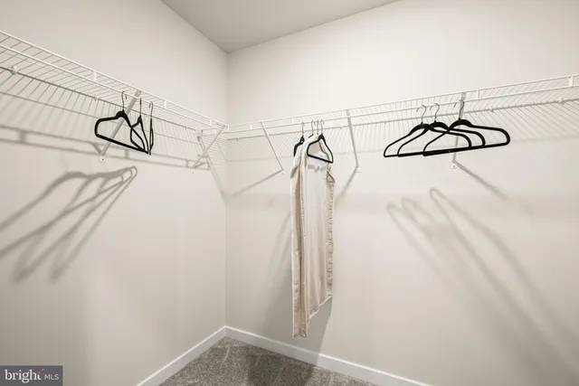 a view of a closet with white walls