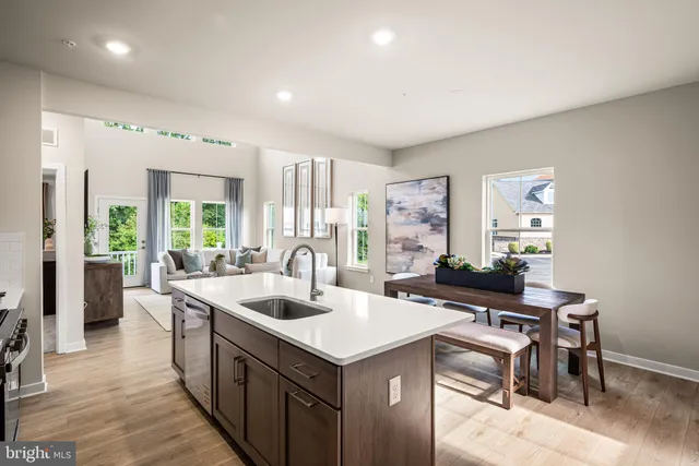 a kitchen with a stove a refrigerator and a sink
