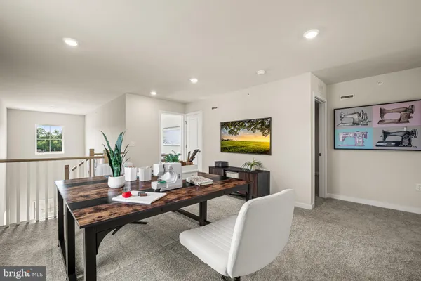 a living room with furniture potted plant and window
