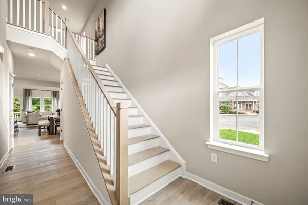 a view of entryway and hall with wooden floor