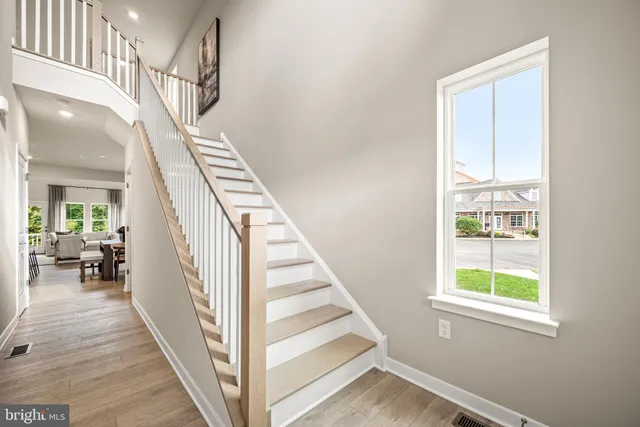 a view of entryway and hall with wooden floor