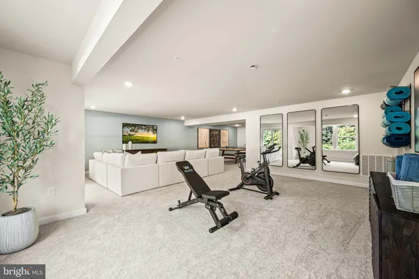 a living room with furniture and potted plants