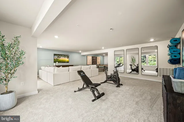a living room with furniture and potted plants