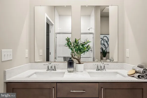 a bathroom with double sink and a mirror