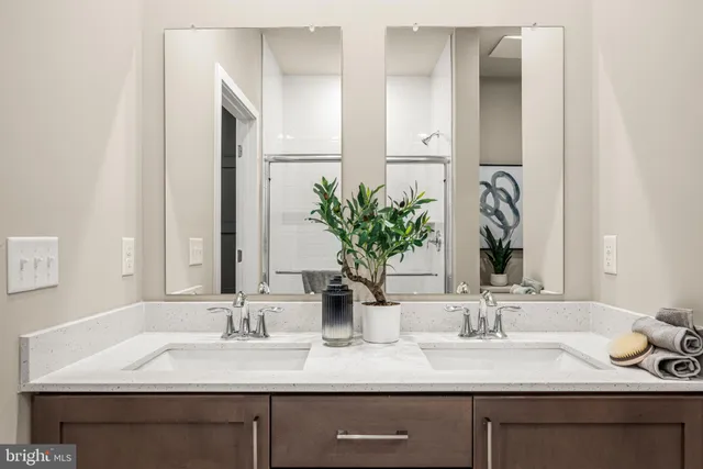 a bathroom with double sink and a mirror