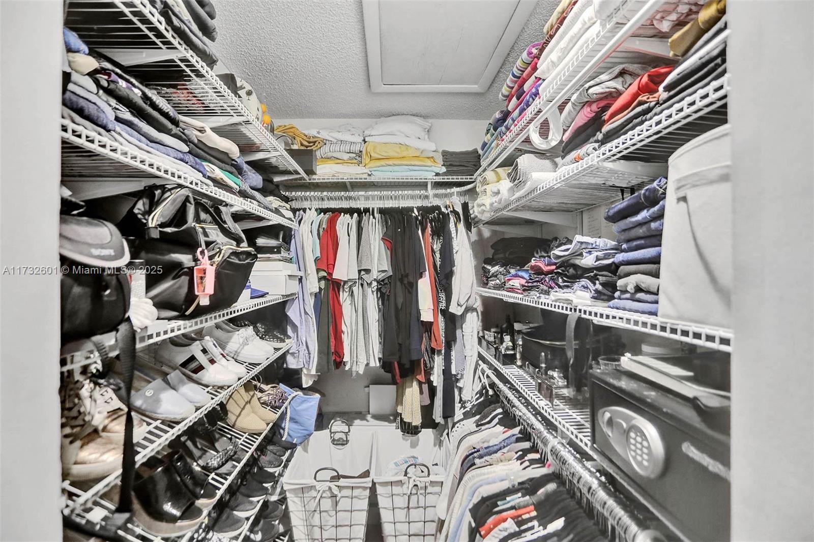 9395 Boca Cove Circle, Unit 1208 Boca Raton, FL 33428 - Photo 20 of 33 a view of walk in closet with clothes