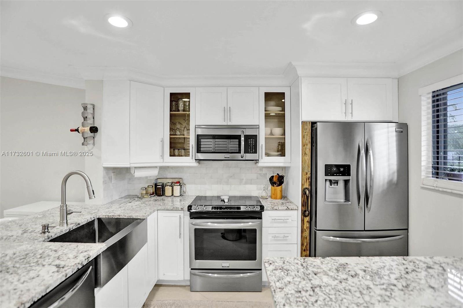 9395 Boca Cove Circle, Unit 1208 Boca Raton, FL 33428 - Photo 2 of 33 a kitchen with stainless steel appliances granite countertop a sink stove and refrigerator