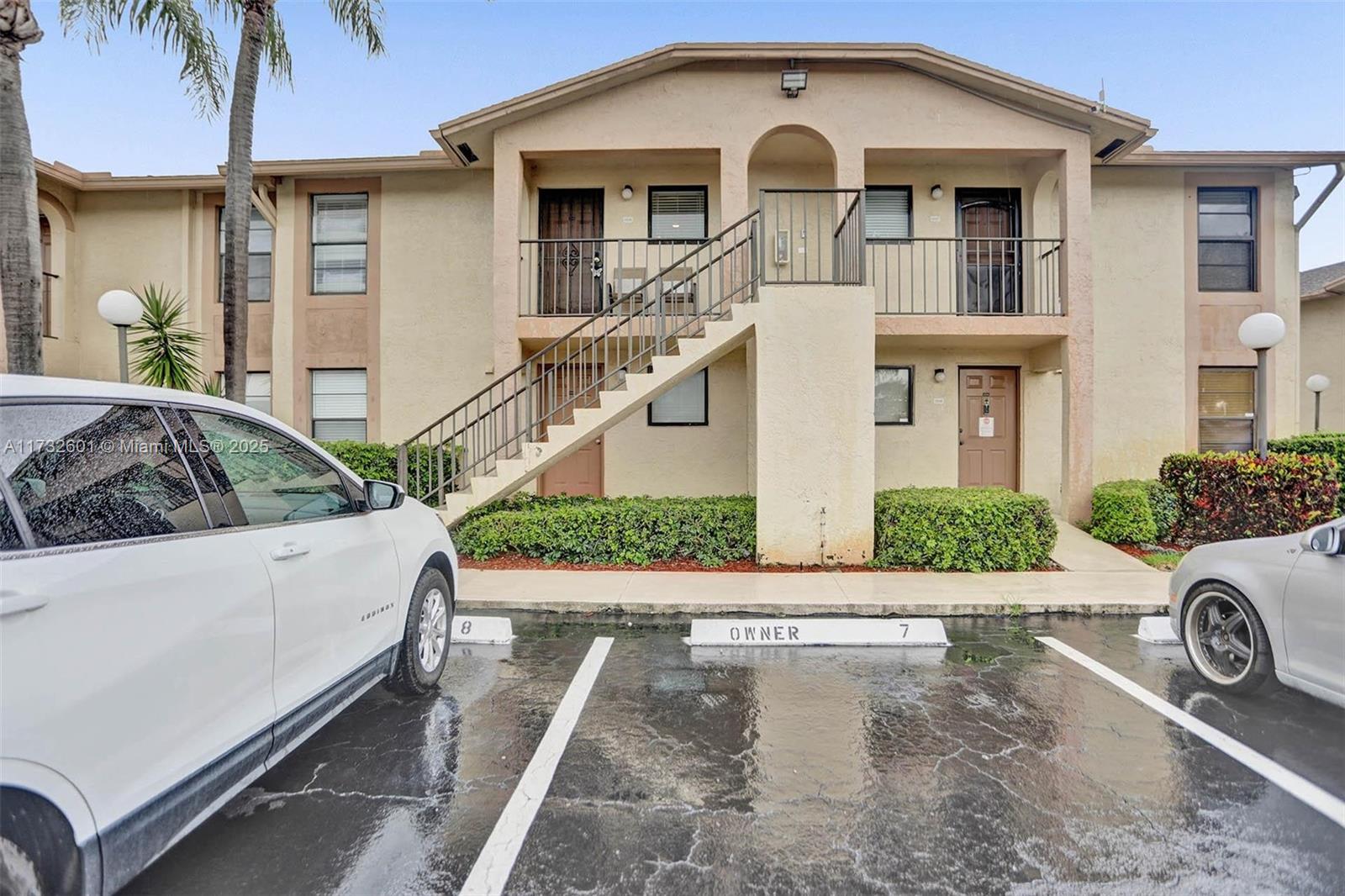 9395 Boca Cove Circle, Unit 1208 Boca Raton, FL 33428 - Photo 28 of 33 a front view of a house with a yard