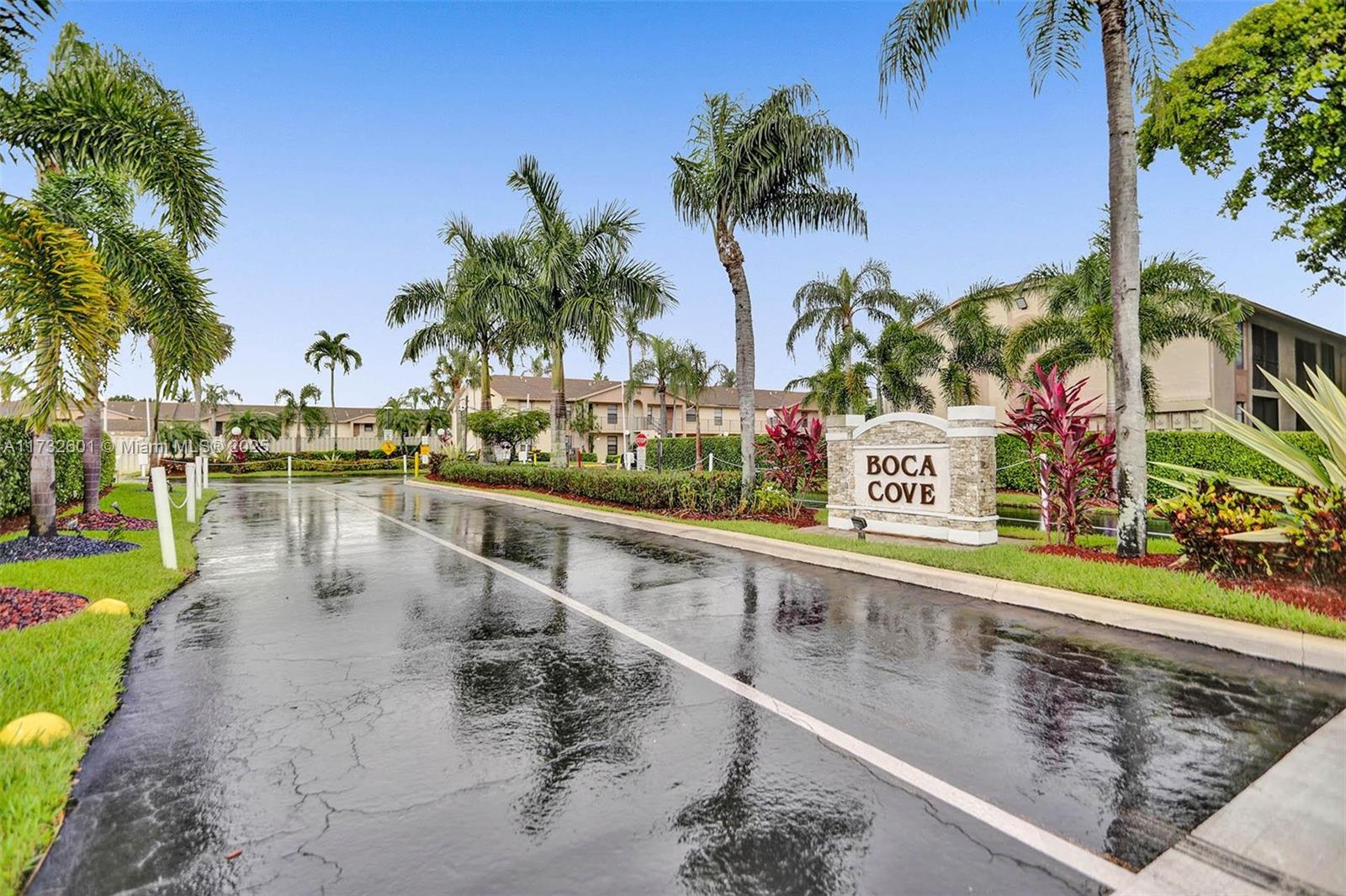 9395 Boca Cove Circle, Unit 1208 Boca Raton, FL 33428 - Photo 29 of 33 a view of a lake with a building and a big yard