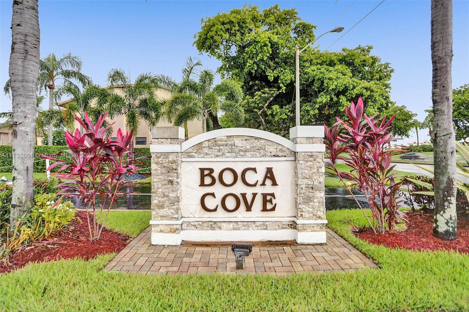 9395 Boca Cove Circle, Unit 1208 Boca Raton, FL 33428 - Photo 30 of 33 a sign that is sitting in front of flowers