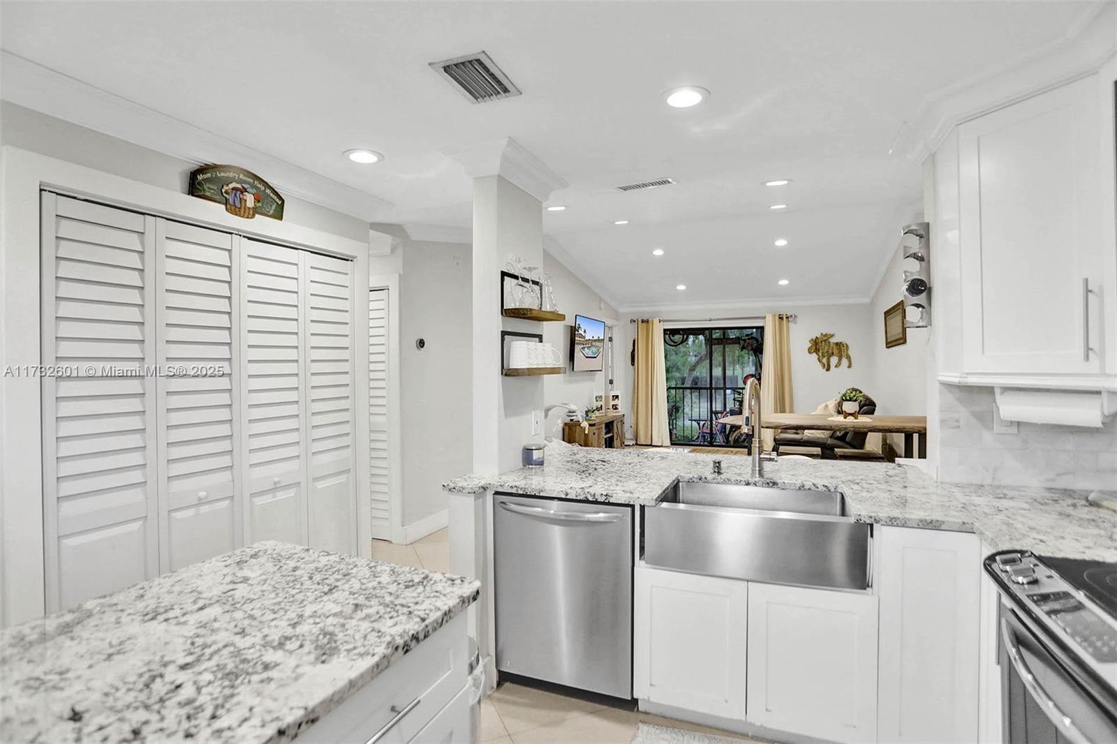 9395 Boca Cove Circle, Unit 1208 Boca Raton, FL 33428 - Photo 4 of 33 a kitchen with stainless steel appliances granite countertop a sink stove and cabinets
