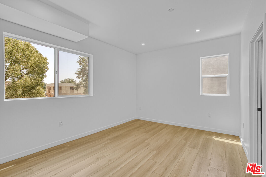 10828 Hesby Street North Hollywood, CA 91601 - Photo 13 of 33 a view of an empty room with wooden floor and a window