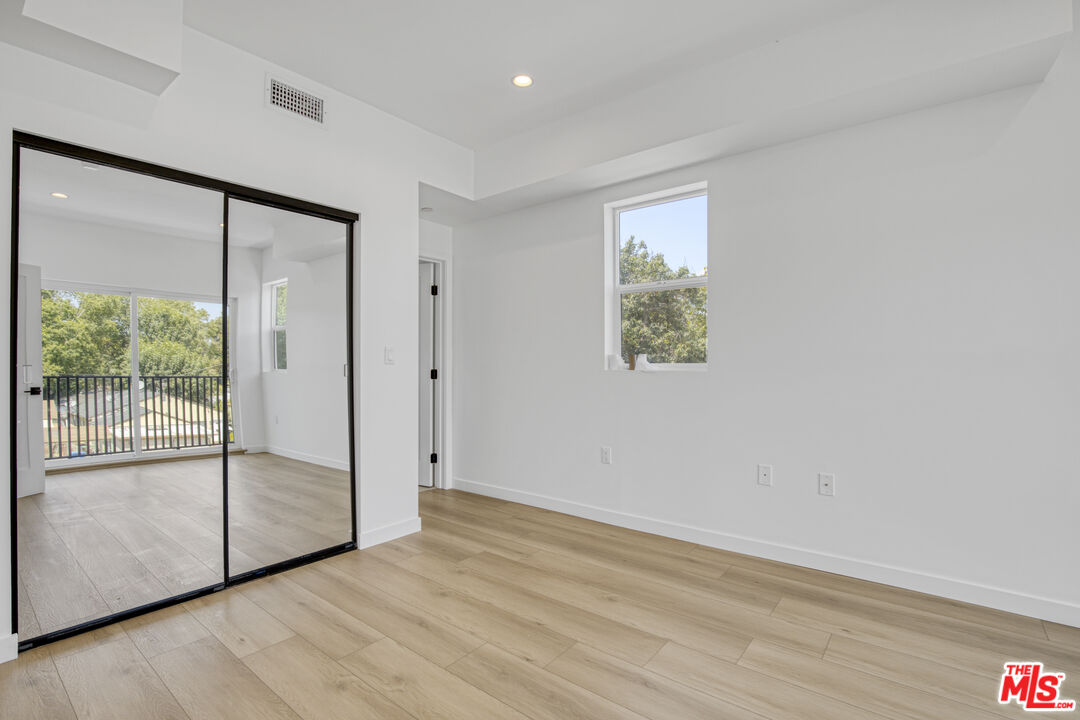 10828 Hesby Street North Hollywood, CA 91601 - Photo 19 of 33 a view of an empty room with wooden floor and next to a window