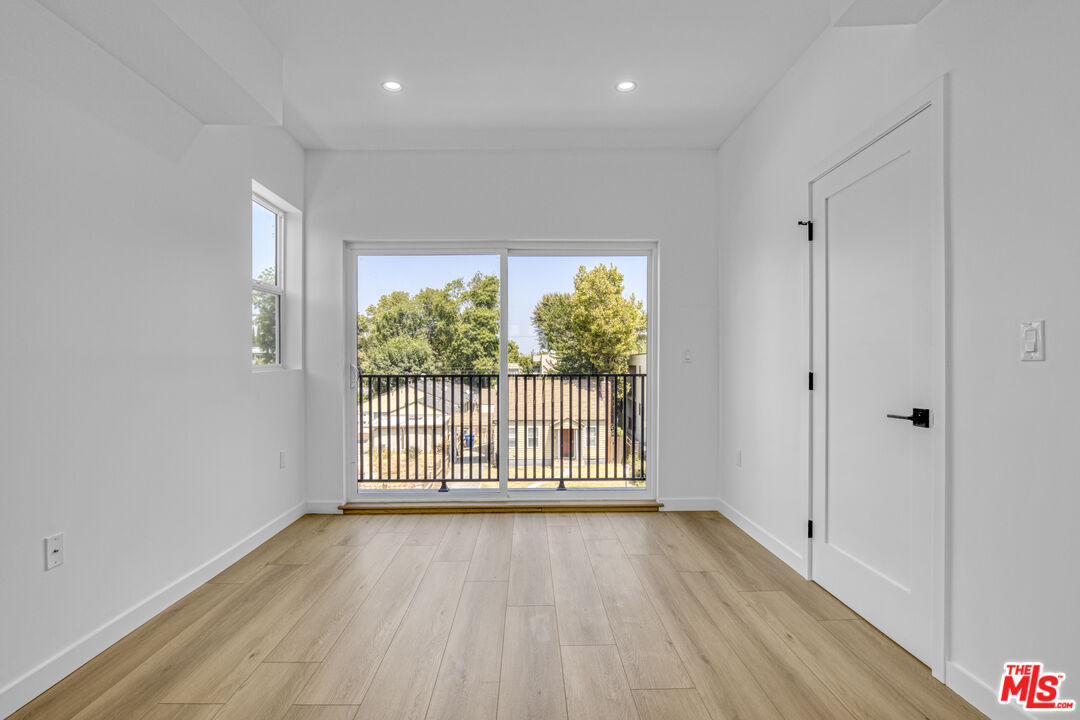 10828 Hesby Street North Hollywood, CA 91601 - Photo 21 of 33 a view of an empty room with wooden floor and a window